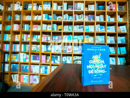 Colorful book shelves packed with books in a library. Stock Photo