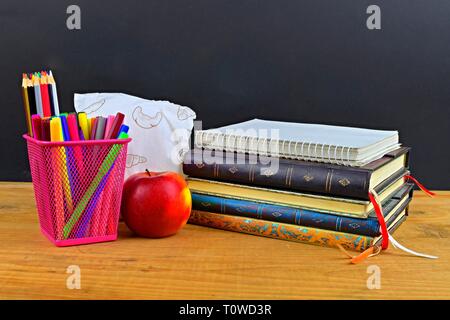 Back to School concept, school supplies. Concept of school lunch break with apple and school supplies on wooden desk, selective focus. Copy space. Stock Photo