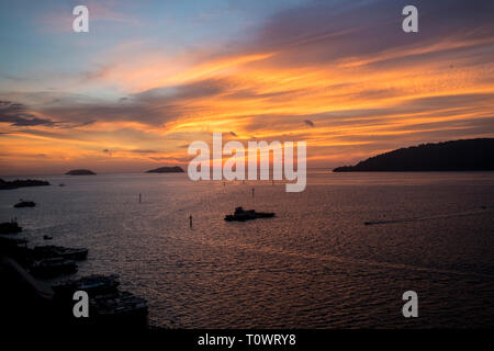 A stunning, beautiful, orange sunset over the South China Sea in Kota Kinabalu, Sabah, Borneo, Malaysia. Stock Photo