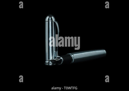 Fountain pen with silver cap on a black background 2019 Stock Photo