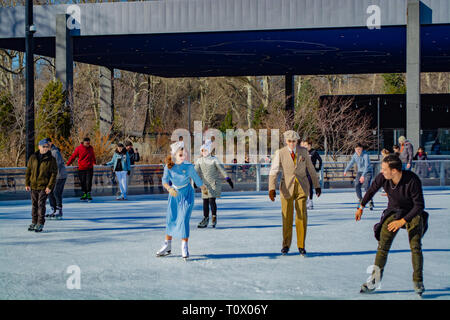Man and woman dressed in the mid 40's are skating at the prospect park skating rink in New York, Brooklyn 2019 Stock Photo