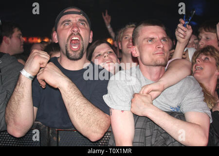 Front row fans are shown rockin out during a 'live' concert performance. Stock Photo