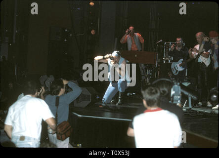 Photographers are shown taking a picture of Ian Anderson and Jethro Tull while the band members photograph the press during during a 'live' concert performance. Stock Photo