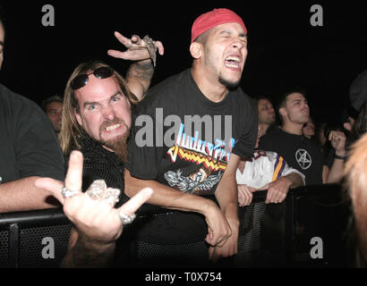 Front row fans are shown pumped up during a 'live' concert performance. Stock Photo