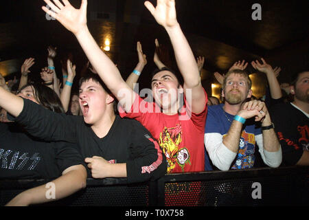 Fans are shown in the front row reaching up to the artist during a 'live' concert performance. Stock Photo