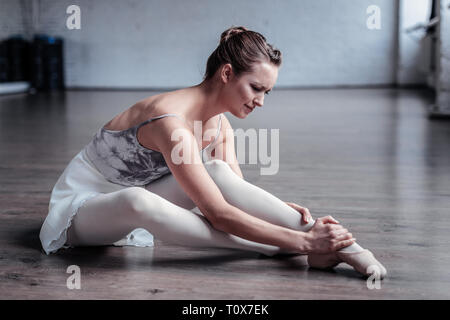 Nice young ballet dancer having a warm up Stock Photo