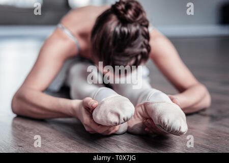 Selective focus of ballet dancers feet in the shoes Stock Photo