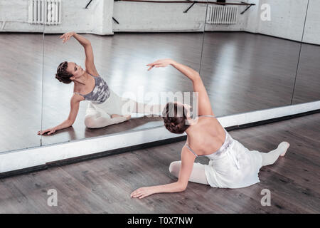 Attractive young woman practicing her dancing movements Stock Photo