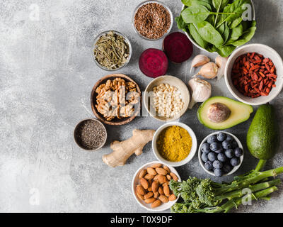 Healthy clean food - vegetables, fruits, nuts, superfoods on a gray background. Healthy eating concept. Stock Photo