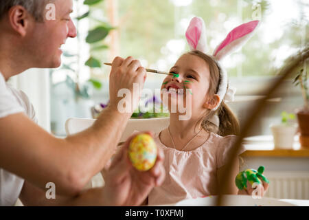 Smiling Child Hand Painting Easter Eggs At Home. Easter, Holidays And 