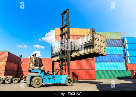 Forklift container loading and unloading cargo into the import-export zone Stock Photo