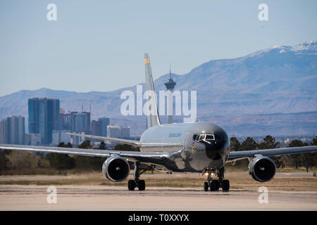 Colombian Air Force Multi-Mission Transport  Tanker Jupiter 767 taxies during Red Flag 19-2 on  the flightline at Nellis Air Force Base, Nev., with the  Las Vegas skyline in the background March 14,  2019. This is the Colombian Air Force’s third time  participating in a Red Flag exercise. They previously  participated in 2012 and 2018 with their Kfir fighter  jets and MMTT Jupiter 767. Red Flag is America’s  premier integration air-to-air combat training  exercise that focuses on readiness, partnership and  integration for expeditionary operations. (U.S. Air Force photo by Tech. Sgt. Angela Ru Stock Photo