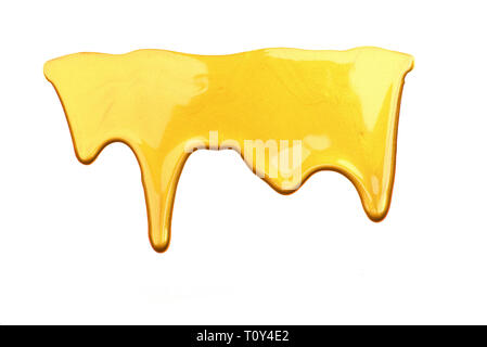 Golden liquid flowing down with stains texture background isolated on white background. Luxurious golden texture of cosmetics, acrylic paints, nail po Stock Photo