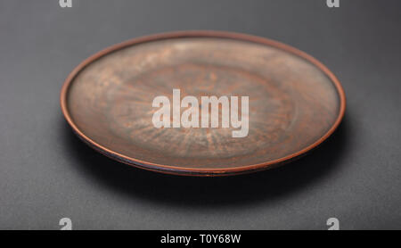 new clay plate closeup on black background Stock Photo