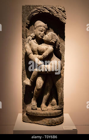 This sculpture of a Mithuna (Loving Couple) dates from the 13th century during the Eastern Ganga dynasty and is made from ferruginous stone. It used to be part of the decoration of a temple facade and is now on display at the Metropolitan Museum of Art in New York City. Stock Photo