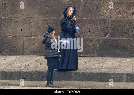 Lyme Regis, Dorset, UK. 22nd March 2019 Mary Queen of Scots star Saoirse Ronan tucks into some fish and chips in Lyme Regis, Dorset, as filming continues for historical drama Ammonite – a story inspired by the life of legendary fossil hunter Mary Anning. The story is set in the 1840s, involving Anning and a young woman sent to convalesce by the sea.   It's directed by Francis Lee, who scooped awards at Sundance in 2017 for his film God's Own Country.  ---- Credit: Apex/Alamy Live News Stock Photo