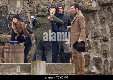 Lyme Regis, Dorset, UK. 22nd March 2019 Mary Queen of Scots star Saoirse Ronan appears on set in Lyme Regis, Dorset, as filming continues for historical drama Ammonite – a story inspired by the life of legendary fossil hunter Mary Anning. The story is set in the 1840s, involving Anning and a young woman sent to convalesce by the sea.   It's directed by Francis Lee, who scooped awards at Sundance in 2017 for his film God's Own Country.   Credit: Apex/Alamy Live News Stock Photo