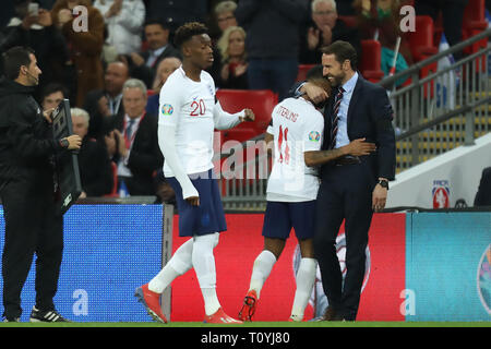 Wembley Stadium, London, UK. 22nd Mar, 2019. UEFA European Championships Qualification football, England versus Czech Republic; England Manager Gareth Southgate embraces Raheem Sterling as he is substituted for Callum Hudson-Odoi Credit: Action Plus Sports/Alamy Live News Stock Photo
