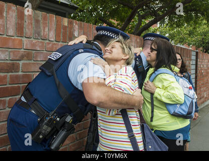 Christchurch, Canterbury, New Zealand. 23rd Mar, 2019. Marchers hug a few police officers during a 'A March for Love' that was organized to unite the community in the wake of a terrorist attack on two city mosques that left 50 people dead. Thousands turned up to march from Hagley Park to the Botanic Gardens, which was organized by three teenagers Credit: PJ Heller/ZUMA Wire/Alamy Live News Stock Photo