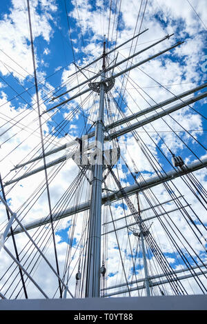 Close up view from old sailboat ship high mast and ropes against clouds and sky Stock Photo