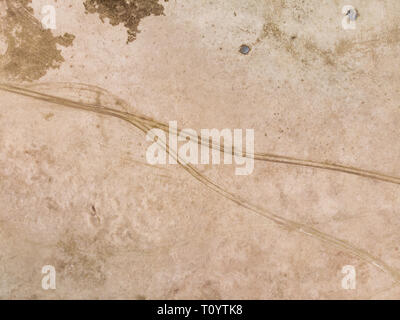The texture of tire tracks on wet sand Stock Photo