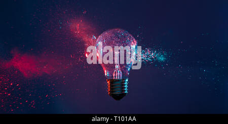 High speed studio photography, moment of the impact of a bullet on a classic electric bulb. Detail of glass explosion, blue and purple lighting. Conce Stock Photo