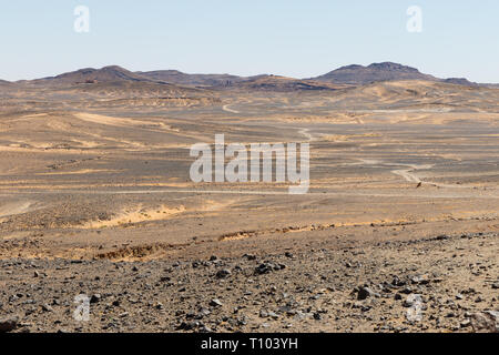 arid landscape in the big sand dunes of Erg Chebbi, Morocco, offer an amazing sight of sand and rocks of the Sahara desert Stock Photo