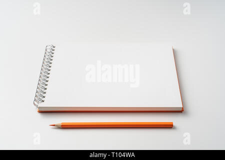 Design concept - perspective view of spiral orange notebook isolated on white background for mockup Stock Photo