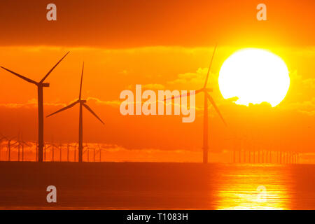 Dawn over off shore Wind turbine farm .Part of Governments policy of providing a higher percentage of wind power by the 1930's . Stock Photo