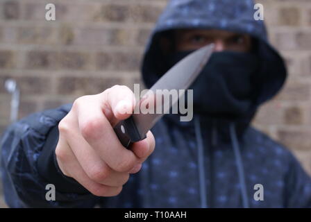teenager carrying a knife Stock Photo