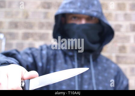 Knife crime, teenager carrying a knife Stock Photo