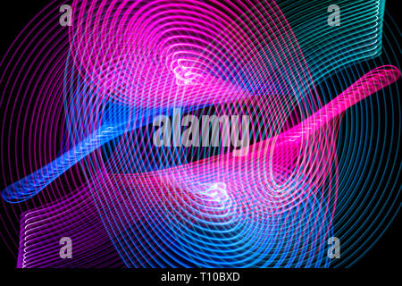 Abstract rainbow blue and pink neon glowing crossing lines pattern. Dark  background of colorful neon glowing light shapes. Stock Photo