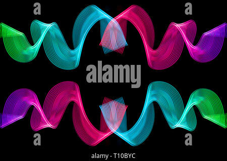 Colorful pink, green, red and pink  neon  spiral lines.Abstract background of pink neon glowing light shapes. Bright stripes for poster, website, broc Stock Photo