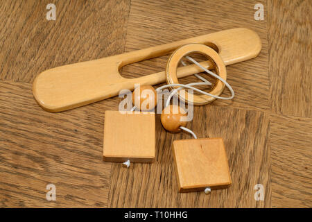 brain teaser wood puzzle on wooden background Stock Photo