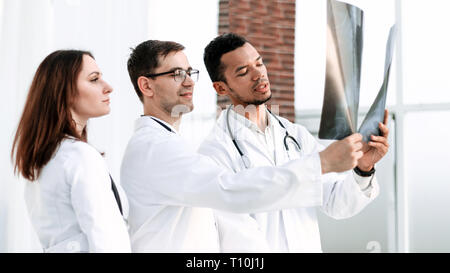 Group of doctors and nurses looking at X-ray Stock Photo