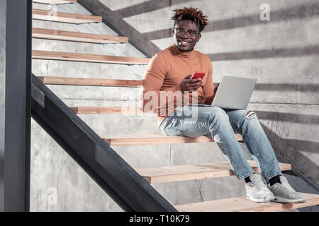 Positive delighted international man working on distance Stock Photo
