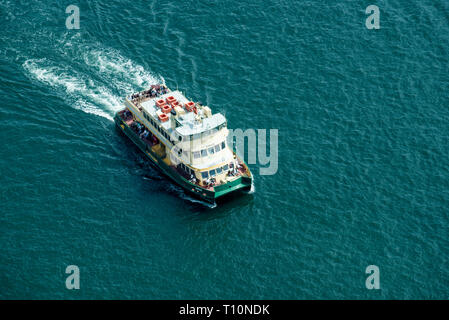 Looking down from an office tower on a Sydney, First Fleet Class ferry moving on Sydney Harbour in the afternoon