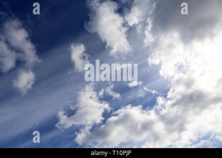 Sky covered with cumulus clouds after the storm. Spring cloudy sky with sun rays, beautiful background for weather Stock Photo