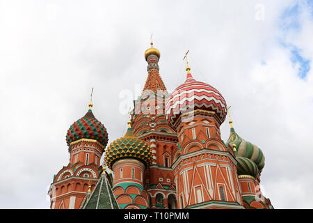 St. Basil's Cathedral against the cloudy sky, white clouds are reflected in windows. Russian architecture landmark, located on Red square in Moscow Stock Photo