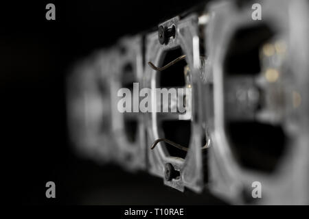 Five outlets in line, disassembled and mounted in black glass wall. Stock Photo
