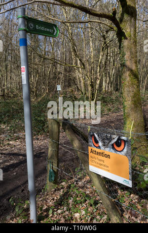 A bridleway landscape and a sign warning fly-tippers of CCTV coverage on a rural lane in Kent, on 19th March 2019, in Westerham, England. Stock Photo