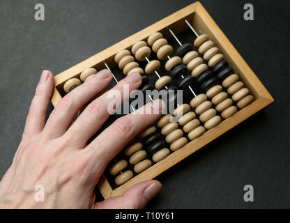 Old wooden abacus on dark background. Stock Photo