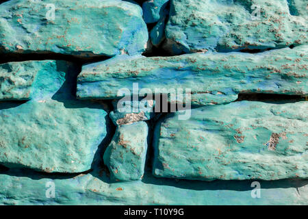 Rough old stone wall, part of stony masonry painting of blue color. Texture background Stock Photo