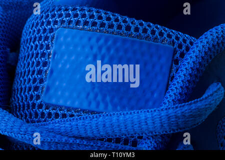 Fragment of a blue sneaker with drawstring macro.Sneaker texture Stock Photo