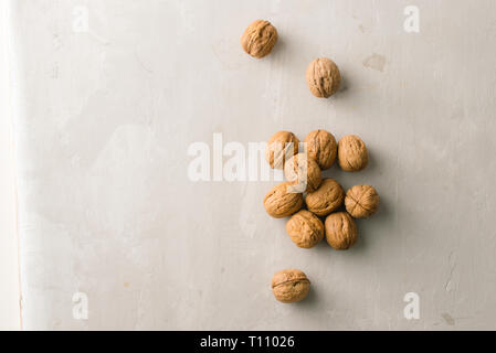 Whole organic walnuts on gray stone table Stock Photo
