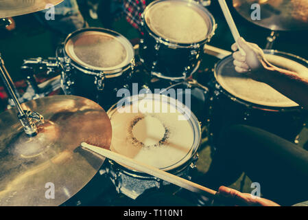 cropped view of drummer holding drum sticks while playing drums Stock Photo