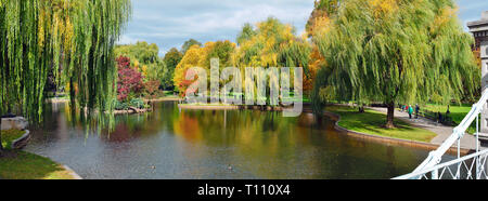 Panoramic view of Boston Public Garden in the Autumn. Colorful fall foliage and water reflections from lagoon bridge Stock Photo