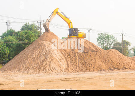 large diesel mechanical excavator digging earth machine at excavation working in road construction Stock Photo