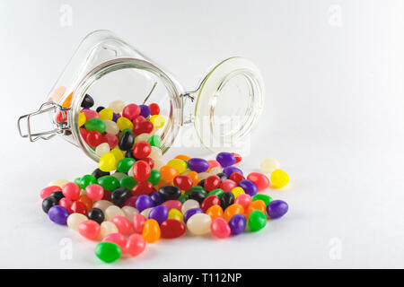 Jelly Beans Spilling from Glass Jar Stock Photo