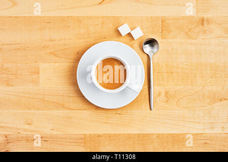 Cup of coffee or espresso with spoon and sugar cubes on wooden table. Top view. Copy space for text. Flat lay. Stock Photo